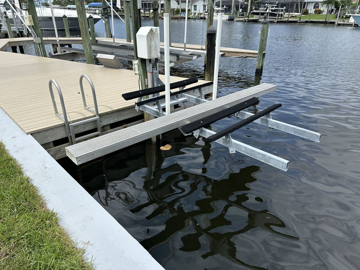 Kayak lift with walkboard beside a dock