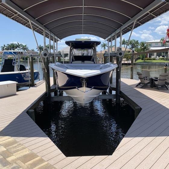 Navy center-console raised on a covered boat lift