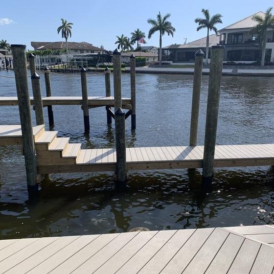 New vinyl dock on pilings with steps down to a lower landing