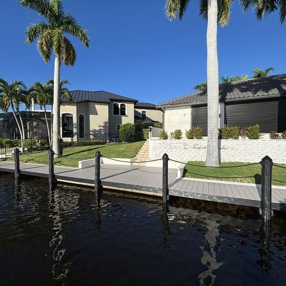 Slate Gray vinyl dock with black fascia and rope rail seen from the water