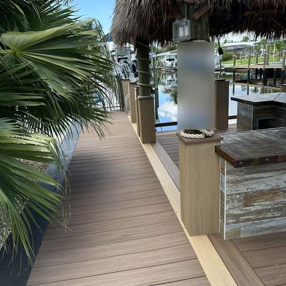 Tiki bar with rope-wrapped posts beside a Brownstone vinyl walkway with picture framing